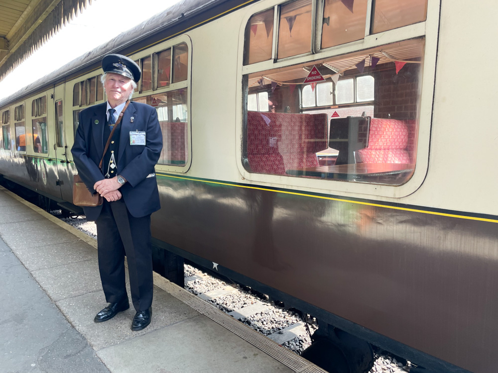 Train conductor waiting to board the train at Dereham station
