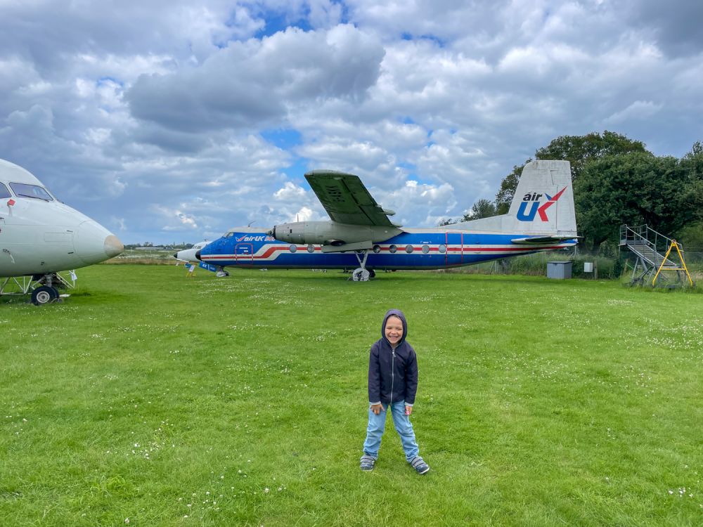 Ben Bertoni in front of a AirUK plane at the City of Norwich Aviation Museum